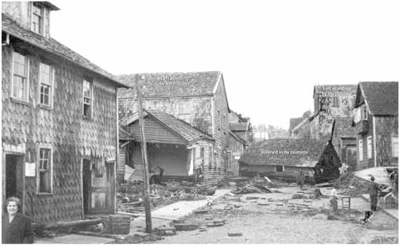 photo of house moved to the middle of a street between other buildings that were not moved